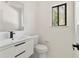Modern half bathroom with stylish vanity, black hardware, and sleek fixtures for a touch of elegance at 8649 Cedar Creek Rdg, Riverdale, GA 30274