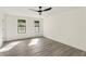 Bright bedroom with wood floors, black ceiling fan, and natural lighting from large windows at 8649 Cedar Creek Rdg, Riverdale, GA 30274