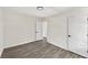 Modern bedroom featuring grey vinyl floors, neutral paint, and two doors at 8649 Cedar Creek Rdg, Riverdale, GA 30274