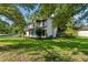 A two-story home surrounded by lush greenery and a well-maintained lawn showing the side of the property at 8649 Cedar Creek Rdg, Riverdale, GA 30274