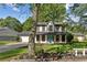 Charming two-story home with a well-maintained front yard, attached garage and a pop of color with an aqua-colored front door at 8649 Cedar Creek Rdg, Riverdale, GA 30274
