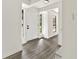 Inviting foyer featuring grey vinyl floors, natural light from two windows, and a bright front door at 8649 Cedar Creek Rdg, Riverdale, GA 30274