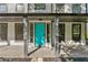 Close-up of a bright aqua front door flanked by sidelights and columns showcasing curb appeal at 8649 Cedar Creek Rdg, Riverdale, GA 30274