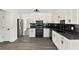 Bright kitchen featuring white cabinets, black countertops and backsplash, and stainless steel refrigerator at 8649 Cedar Creek Rdg, Riverdale, GA 30274