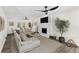 Bright living room with fireplace, modern ceiling fan, neutral furniture and ample natural light creating an inviting atmosphere at 8649 Cedar Creek Rdg, Riverdale, GA 30274