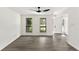 Bright and airy living room with hardwood-style flooring, two windows and a contemporary ceiling fan at 8649 Cedar Creek Rdg, Riverdale, GA 30274