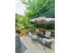 Inviting back deck features comfortable seating beneath a shade umbrella and has a wooded view at 227 Bennett Farms Trl, Acworth, GA 30102