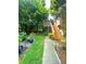 Backyard with deck featuring landscaped yard, path to the grass, and shade trees at 227 Bennett Farms Trl, Acworth, GA 30102