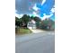 Traditional home with a two-car garage, long driveway and a manicured front yard under a cloudy sky at 227 Bennett Farms Trl, Acworth, GA 30102
