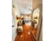 Hallway leading to the living room, featuring hardwood floors, mirrors, and stylish decor at 227 Bennett Farms Trl, Acworth, GA 30102