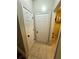 Hallway with tile floors and doors leading to storage and other rooms at 227 Bennett Farms Trl, Acworth, GA 30102