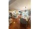 Spacious kitchen and dining area with hardwood floors, island seating, and stainless steel appliances at 227 Bennett Farms Trl, Acworth, GA 30102
