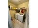Well-organized laundry room with newer machines, shelving, and tile flooring at 227 Bennett Farms Trl, Acworth, GA 30102