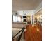 Open-concept living room with hardwood floors, a fireplace, and views into the kitchen at 227 Bennett Farms Trl, Acworth, GA 30102