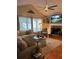 Cozy living room features a stone fireplace, hardwood floors, and large windows at 227 Bennett Farms Trl, Acworth, GA 30102