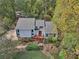 Aerial view of a home with mature trees, stone accents, and inviting front porch at 2653 Partridge Trl, Duluth, GA 30097
