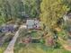 Beautiful aerial view of a home with long driveway, mature trees, and well-maintained landscaping at 2653 Partridge Trl, Duluth, GA 30097
