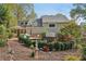 Spacious backyard featuring a lush garden, patio area, and mature trees at 2653 Partridge Trl, Duluth, GA 30097