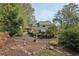 Spacious backyard with mature trees, a charming playhouse, and lush landscaping at 2653 Partridge Trl, Duluth, GA 30097