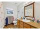 Well-lit bathroom with tile flooring, a single sink vanity, and flamingo-themed shower curtain at 2653 Partridge Trl, Duluth, GA 30097