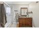 Well-lit bathroom featuring a stand-up shower and wood vanity with sink at 2653 Partridge Trl, Duluth, GA 30097