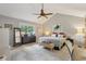 Main bedroom with ceiling fan, a dresser, standing mirror, and bright natural light at 2653 Partridge Trl, Duluth, GA 30097