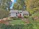A lovely home with a manicured lawn and beautiful landscaping including mature trees in the background at 2653 Partridge Trl, Duluth, GA 30097
