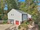 Charming home featuring gray siding, a red garage door, and a cozy covered entry at 2653 Partridge Trl, Duluth, GA 30097