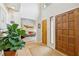 Open foyer with hardwood floors, a view of the living room, and a striking front door at 2653 Partridge Trl, Duluth, GA 30097