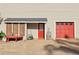 View of garage with red door and extra exterior storage with red bench at 2653 Partridge Trl, Duluth, GA 30097