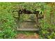 Beautiful garden swing bench surrounded by climbing ivy and lush foliage for serene outdoor relaxation at 2653 Partridge Trl, Duluth, GA 30097