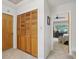 Hallway featuring closet with shuttered doors leading to a bedroom with a ceiling fan at 2653 Partridge Trl, Duluth, GA 30097