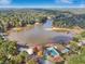 Aerial view of Cardinal Lake featuring a pool, clubhouse, playground, and beautiful fall foliage at 2653 Partridge Trl, Duluth, GA 30097