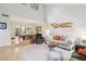 Open-concept living room with high ceilings, decorative wall art, and seamless flow to the dining area at 2653 Partridge Trl, Duluth, GA 30097