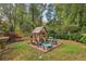Charming backyard playhouse with outdoor seating, nestled among greenery and colorful flowers at 2653 Partridge Trl, Duluth, GA 30097