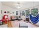Cozy sun room with wicker furniture, lots of windows, and a relaxing hammock for enjoying the outdoors at 2653 Partridge Trl, Duluth, GA 30097