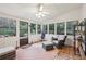 Relaxing sunroom with multiple windows, neutral decor and a ceiling fan at 2653 Partridge Trl, Duluth, GA 30097