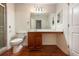 Bathroom featuring a tiled shower with a glass door, toilet, and single sink vanity at 300 Johnson Ferry Ne Rd # B808, Atlanta, GA 30328