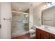 Bathroom featuring a tiled shower with a glass door, toilet, and single sink vanity at 300 Johnson Ferry Ne Rd # B808, Atlanta, GA 30328