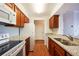 Well-lit kitchen with white appliances, wood cabinets, and granite countertops at 300 Johnson Ferry Ne Rd # B808, Atlanta, GA 30328