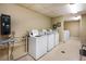 The community laundry room, featuring coin operated machines, folding table and an ironing board at 300 Johnson Ferry Ne Rd # B808, Atlanta, GA 30328