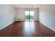 Open concept living space features hardwood floors, neutral walls and a sliding door to the private balcony at 300 Johnson Ferry Ne Rd # B808, Atlanta, GA 30328