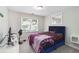 Neutral toned bedroom with large window, light walls, and a modern upholstered bed at 4062 Brookside Pkwy, Decatur, GA 30034
