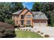 Charming two-story brick home features a well-manicured lawn and a three-car garage at 4062 Brookside Pkwy, Decatur, GA 30034