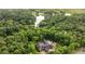 Aerial view of an estate nestled among a lush forest and alongside a scenic lake at 114 Lees Lake Rd, Fayetteville, GA 30214