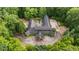 Estate aerial view of the secluded home highlighting lush landscape, custom courtyard, and circle drive at 114 Lees Lake Rd, Fayetteville, GA 30214