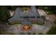 Aerial view of a sprawling custom home with distinctive architecture, beautifully landscaped grounds, and a private setting at 114 Lees Lake Rd, Fayetteville, GA 30214