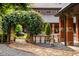 Idyllic backyard with stone pathway, decorative planters, and mature trees at 114 Lees Lake Rd, Fayetteville, GA 30214