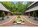 Elegant backyard featuring manicured gardens, a tranquil pond, and stone accents at 114 Lees Lake Rd, Fayetteville, GA 30214