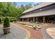 Exterior shot showcasing landscaping, gravel paths, a serene pond, and stone architecture at 114 Lees Lake Rd, Fayetteville, GA 30214